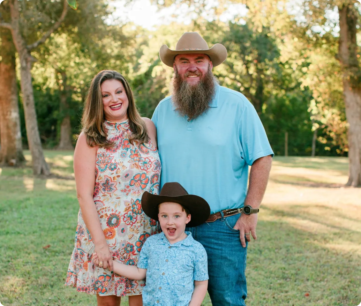 Smiling family with cowboy hats